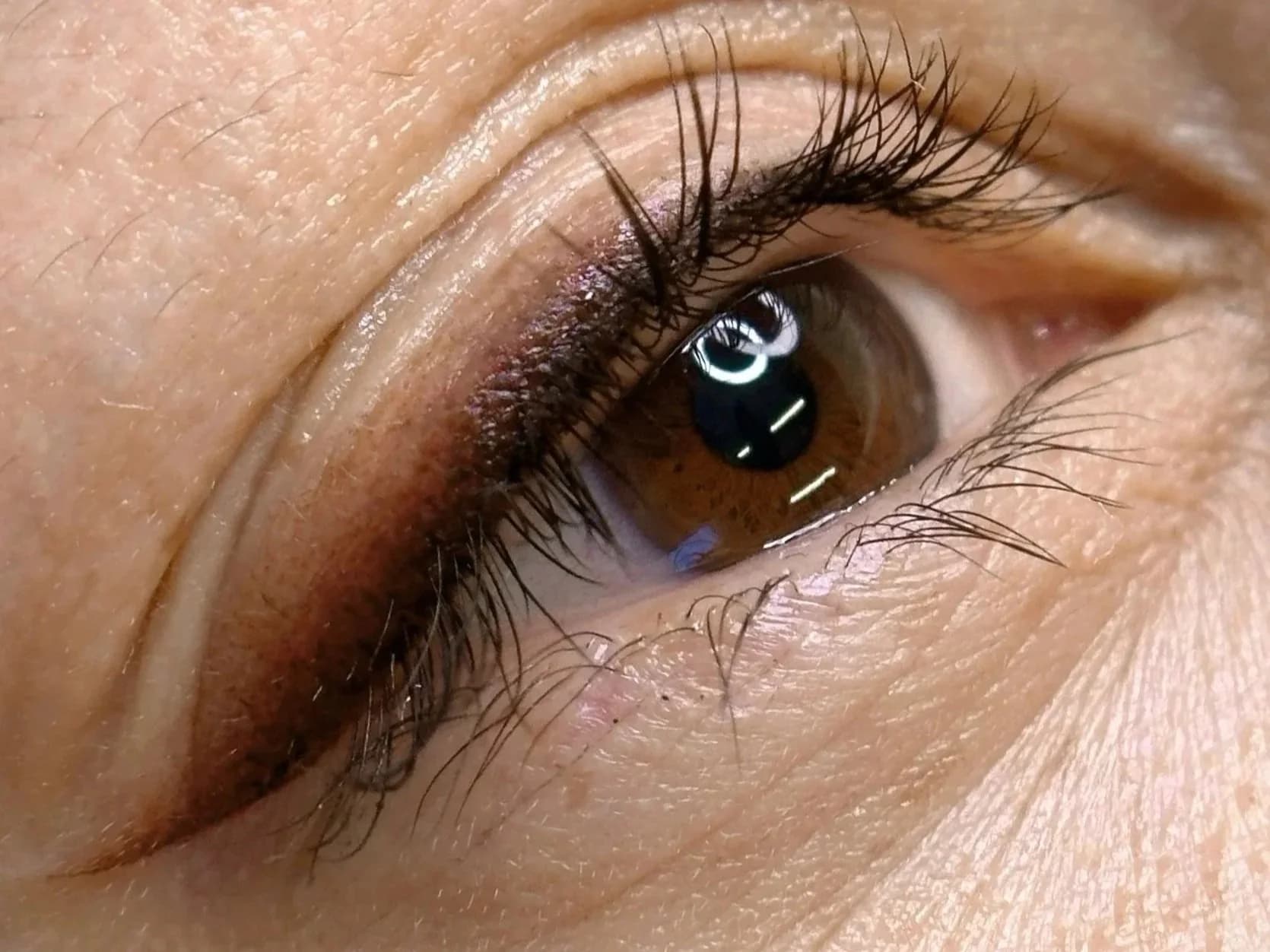 Close up of eye showing eyeliner cosmetic ink work